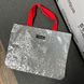 Reflective shopper Svitashka Cobweb with short red handles on a magnetic button