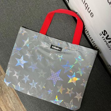 Reflective Svitashka Star shopping bag with short red handles on a magnetic button