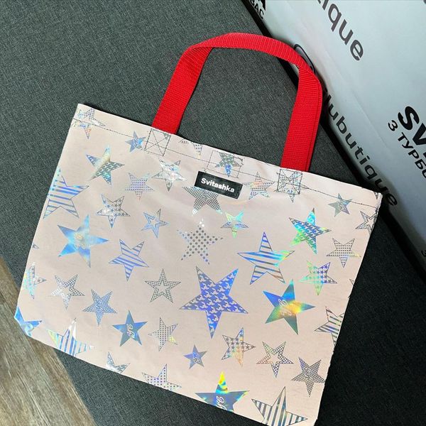 Reflective Svitashka Star shopping bag with short red handles on a magnetic button